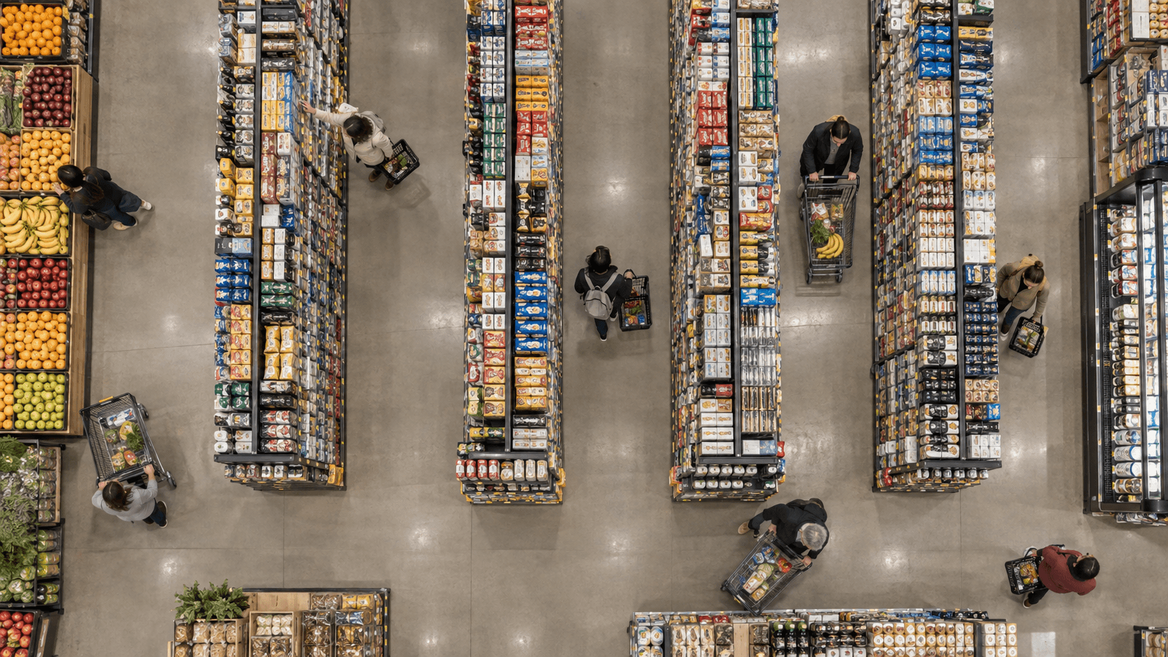 Overhead grocery store with shoppers, shopping carts, stocked aisles, and a produce display