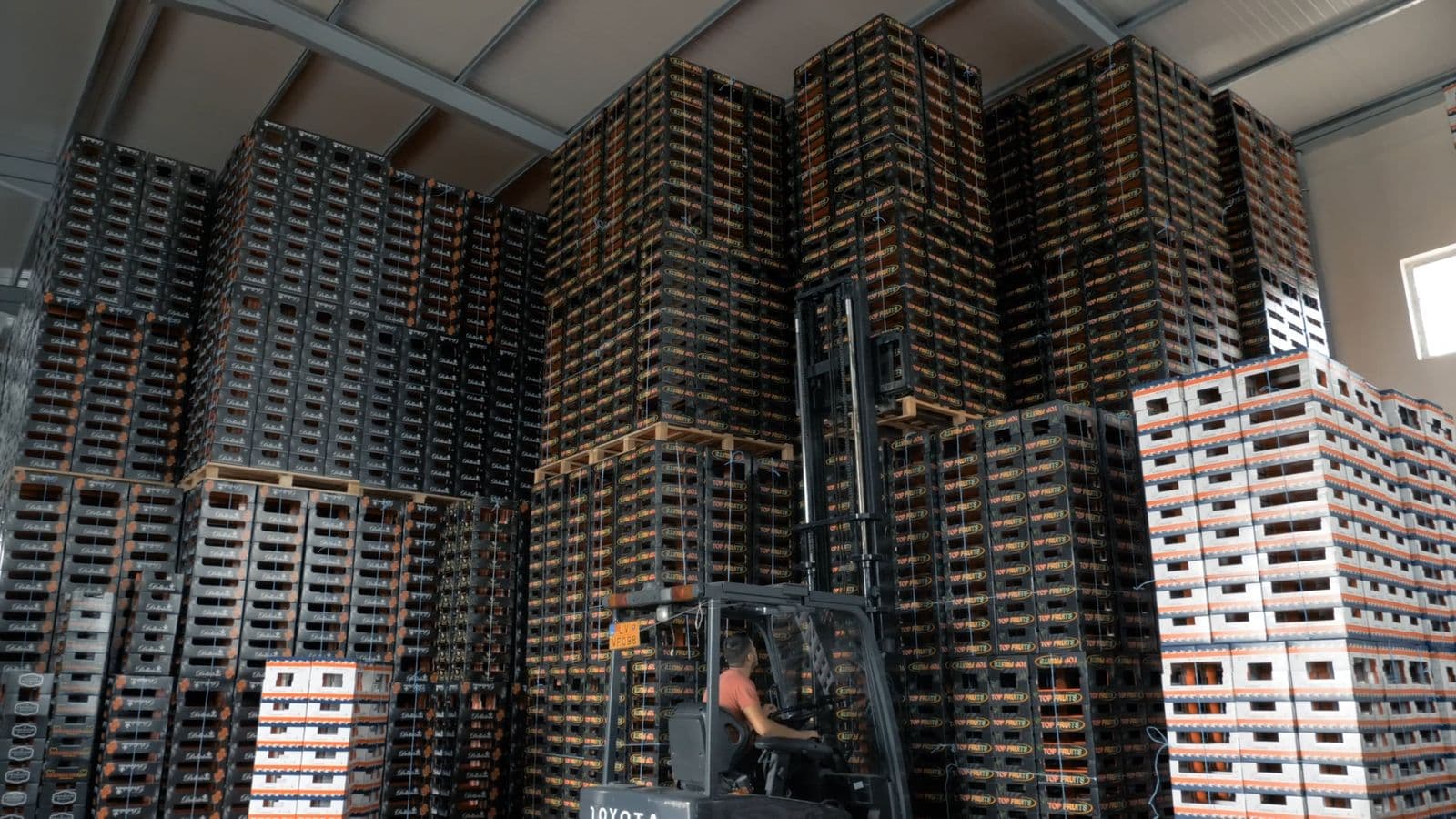 A forklift moving inventory in a warehouse